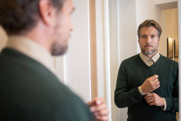 istock Businessman getting dressed in front of the mirror 1458599641