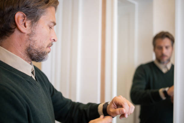 istock Businessman getting dressed in front of the mirror 1458599652