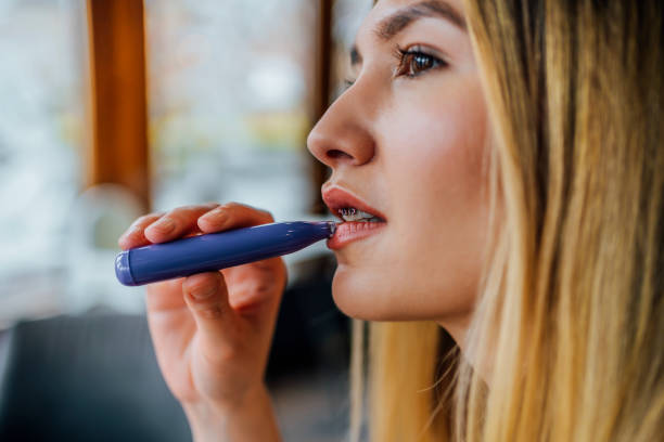 istock Woman smokes disposable vape cigarette 1458602501