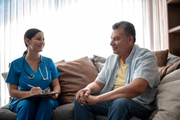 istock Young nurse using a clipboard while talking to a mature man during consultation at nursing home 1458602572
