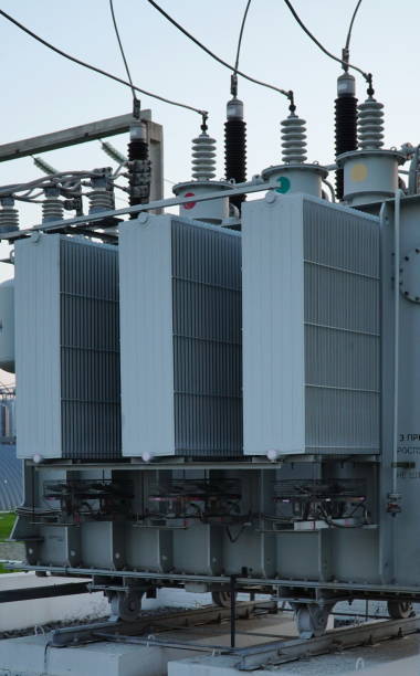 istock Power transformer. Electrical equipment. Electric substation. High voltage transformer against the blue sky. Electric current redistribution substation 1458602929