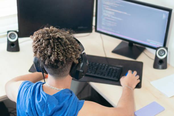 istock Male programmer working at his desk at home 1458604049