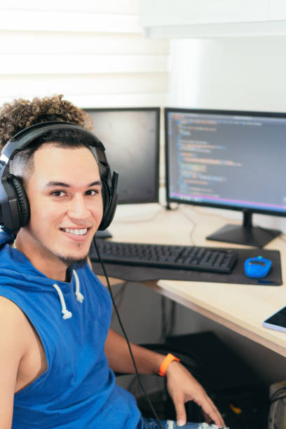 istock Portrait of a computer programmer working at home, looking at the camera smiling. 1458604647
