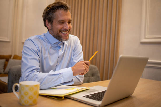 istock Mid adult man working from home 1458606725