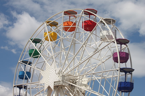 Rainbow colored cars on a Ferris Wheel in Barcelona Spain