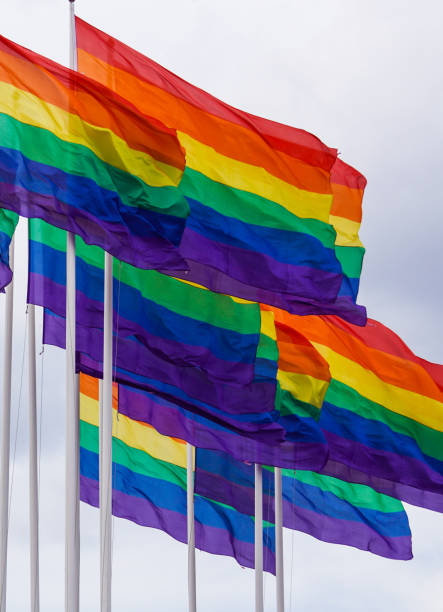 istock Low angle view of rainbow flags against sky 1458610341