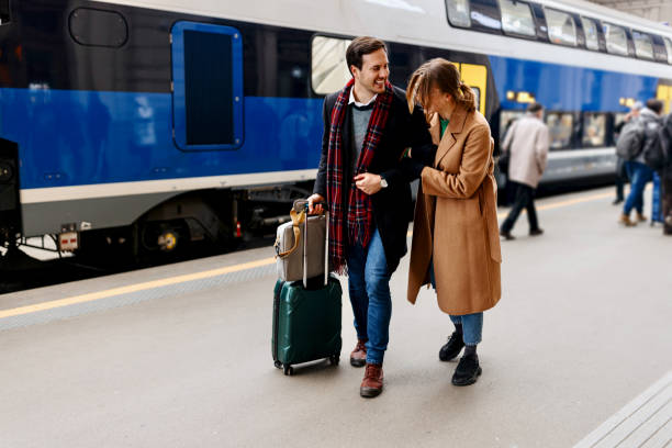 istock Happy couple exiting train station platform 1458610391
