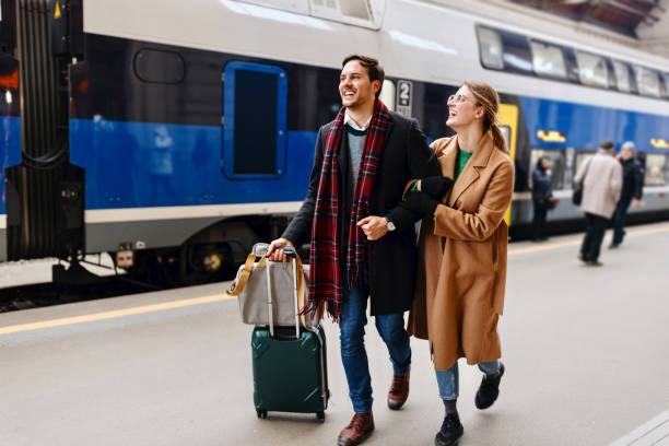 istock Happy couple exiting train station platform 1458610547