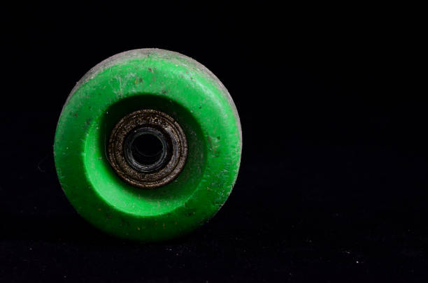 Old Vintage Consumed Skate Wheel on a Black Background