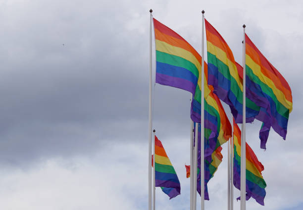 istock Low angle view of rainbow flags against sky 1458611765
