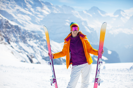 Semi profile photo of a young blond woman during a ski trip on a mountain