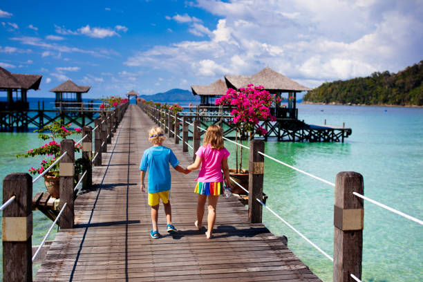 istock Kids on tropical beach. Child on resort jetty. 1458612444