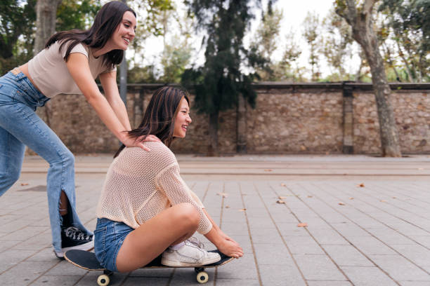 istock friends playing and having fun with a skate 1458613548