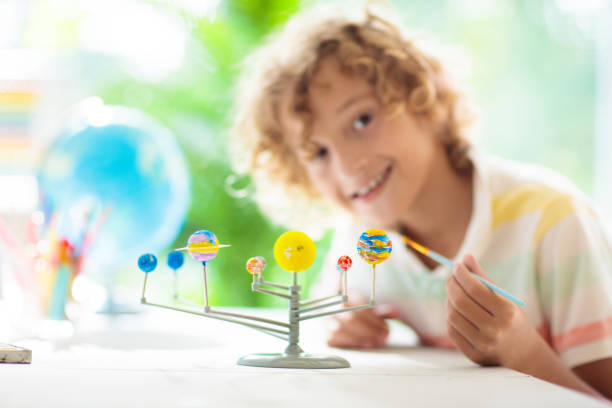istock Child with solar system model. Kids planetarium. 1458614105