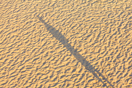 One man shadow on the sandy beach