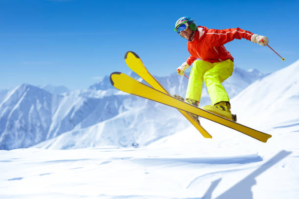 Skier doing a backflip jump in Alps ski resort, Alpe di Mera, Piedmont, Italy