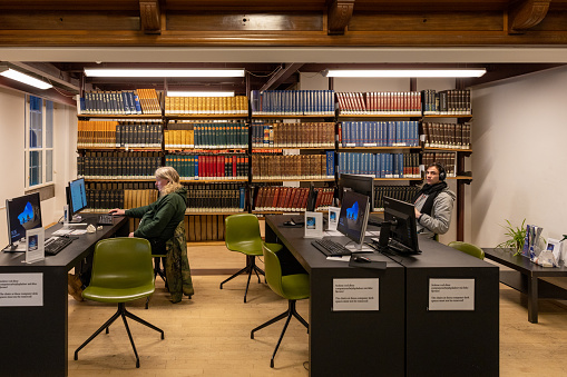 Copenhagen, Denmark Jan 17, 2023 People studying inside the Black Diamond Royal Library wit comouters.