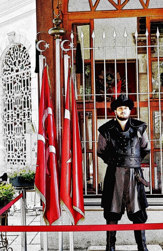 Bursa, Turkey in July 2022. Photo illustration of a man who is a soldier guarding the tomb of Osman Ghazi. This man is wearing traditional Turkish clothing.