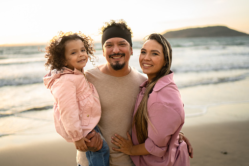 Portrait of parents with their daughter at beach