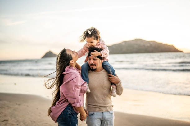 istock Family walking on the beach 1458617262
