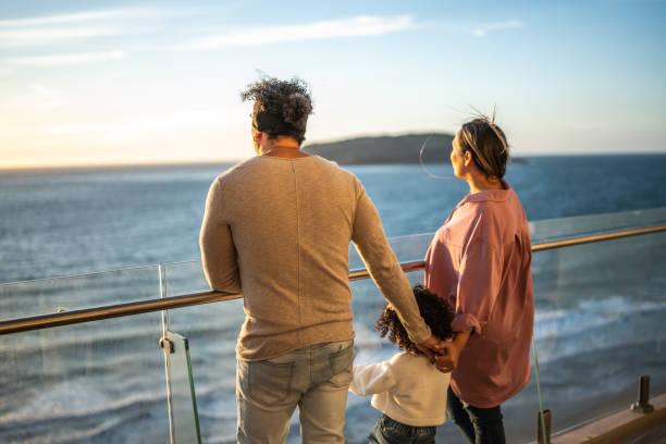 Family looking to the landscape during a cruise travel Family looking to the landscape during a cruise travel tourist couple candid travel stock pictures, royalty-free photos & images