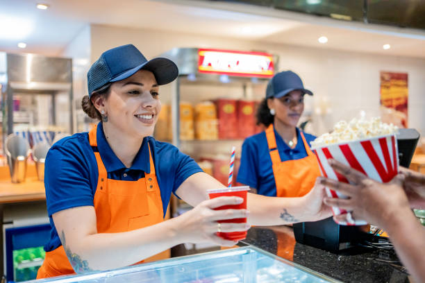 asistente entregando palomitas de maíz y refrescos - cinta para caja registradora fotografías e imágenes de stock