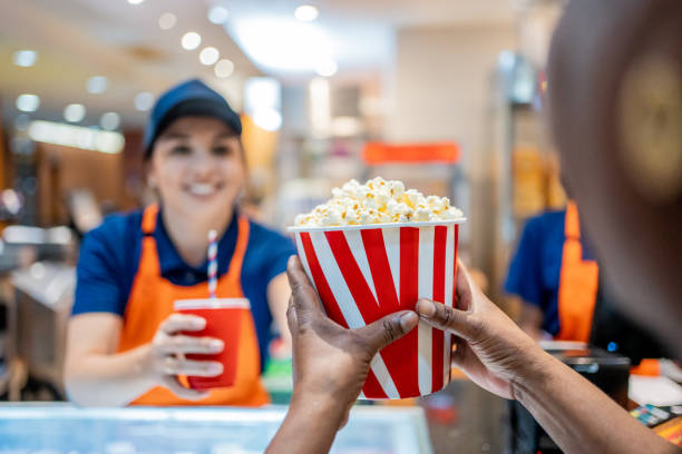 istock Attendant delivering popcorn and soda 1458634102