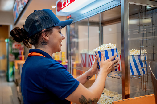 Attendant delivering popcorn to customers