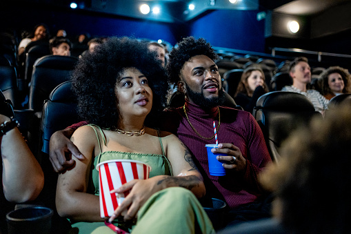 Black couple smiling at the cinema