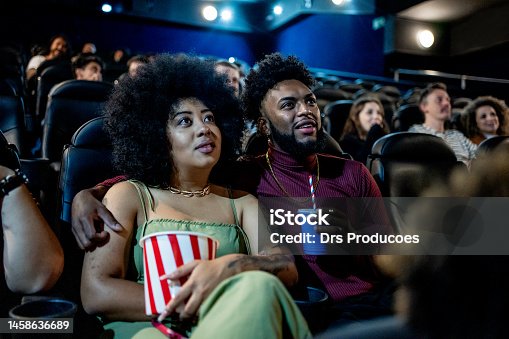 istock Black couple smiling at the cinema 1458636689
