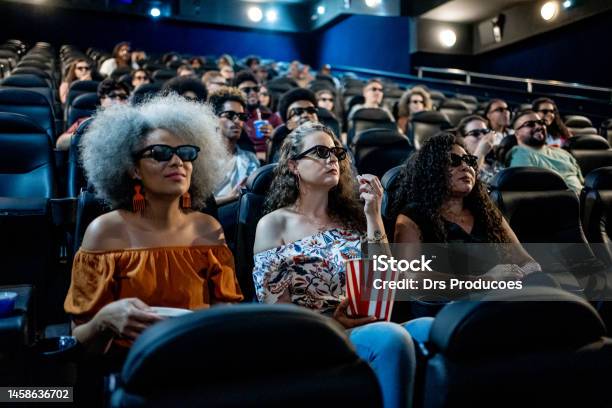 Mature Female Friends Watching 3d Movie At Cinema Stock Photo - Download Image Now - Movie Theater, Movie, Film Industry