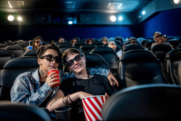 Trans man with his girlfriend at the cinema Trans man with his girlfriend at the cinema cinematography stock pictures, royalty-free photos & images