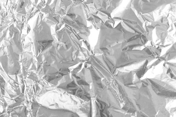 istock Silver foil leaf shiny texture, abstract grey wrapping paper for background and design art work. 1458650647