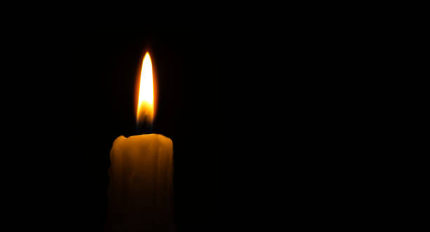istock Close-up of a candle flame against a black background 1458651574