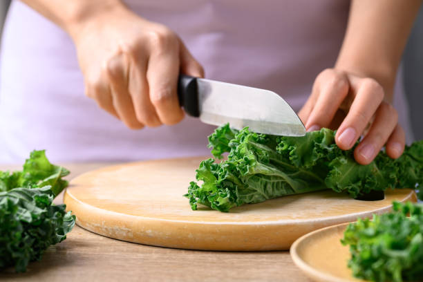 istock Green Kale or leaf cabbage cutting on wooden board, Healthy vegetable 1458662931