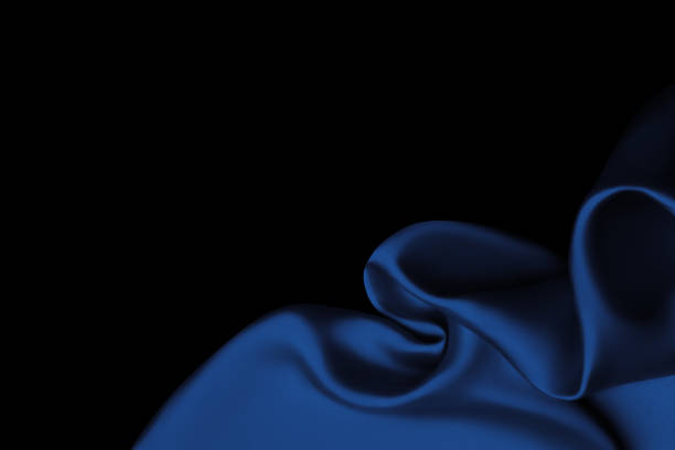 istock Blue satin fabric lays on the surface in the form of openwork folds, silk background, satin background 1458663393