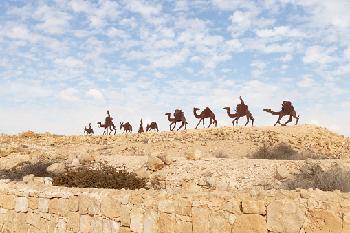 Mitzpe Ramon, Israel, December 14, 2022 : Abstract caravan made of iron near ruins of Nabatean fortress city Avdat, on trade route called Road of Incense, near Mitzpe Ramon city, in southern Israel