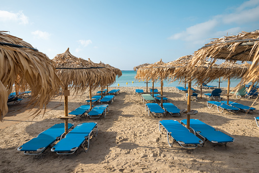 Empty sunbeds in the early morning on the Elafonissi beach. Crete island, Greece.