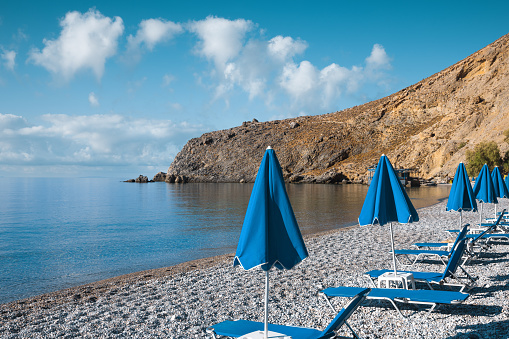 Sunbeds on famous Sweet water beach (Glyka Nera) in South Crete.