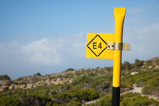 Metal E4 sign showing the walking path In Crete.