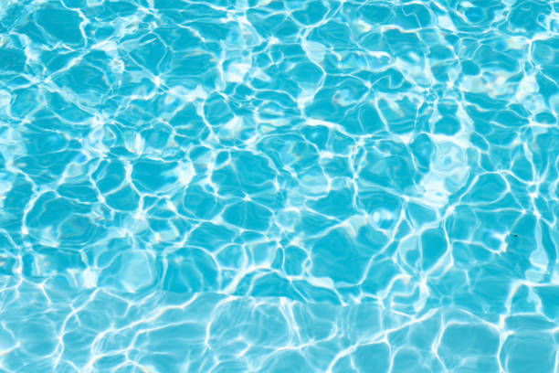 istock Water ripple in swimming pool abstract light blue and white seamless patterns background 1458675525