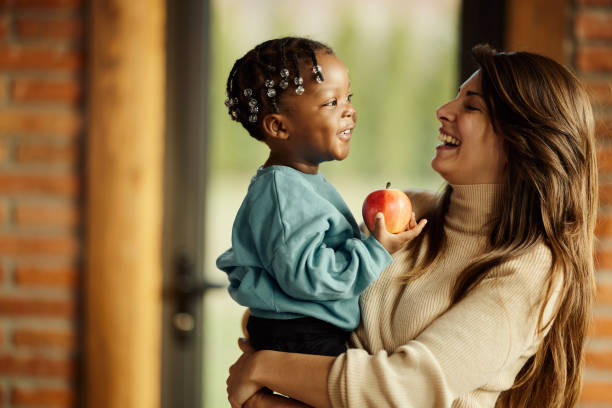 istock Happy mother enjoying with her adopted son at home. 1458676277