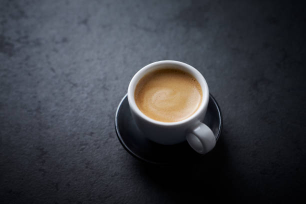 istock Cup of coffee on dark stone background. Close up. 1458676899
