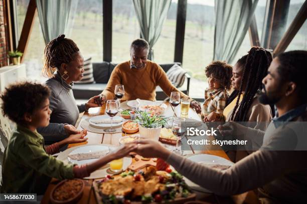 Praying Before A Meal Stock Photo - Download Image Now - Praying, Family, Gratitude