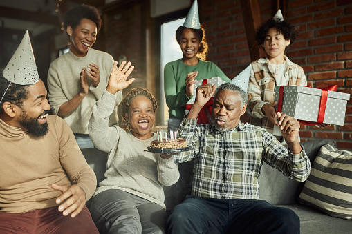 Cheerful African American multi-generation family having fun during a Birthday party at home.