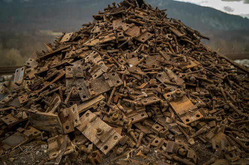 Scrap metal waste is stored in a recycling yard waiting to be melted down to manufacture new products.