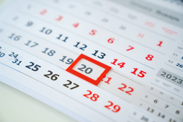 the red tab on the flip calendar page. the concept of transience of time and planning. production of souvenir printed materials.