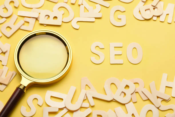 istock SEO concept. Search engine optimization SEO word written on the yellow background with magnifying glass and wooden letters 1458678750