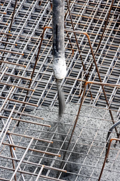 Concrete pouring during house building, concreting slabs of building Steel reinforcement of a base plate. Construction building site concrete in formwork stock pictures, royalty-free photos & images