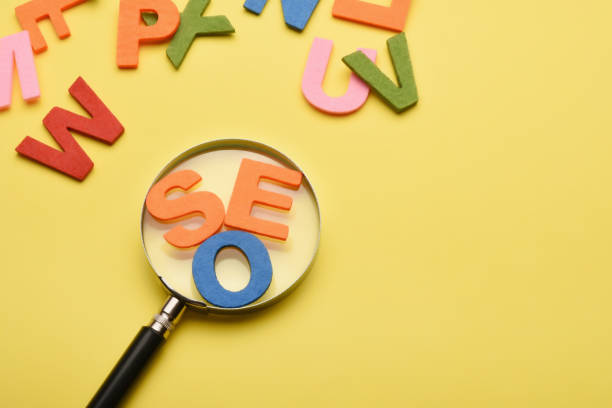 istock SEO concept. Search engine optimization SEO word with magnifying glass and colorful letters on the colored background with copy space 1458679728